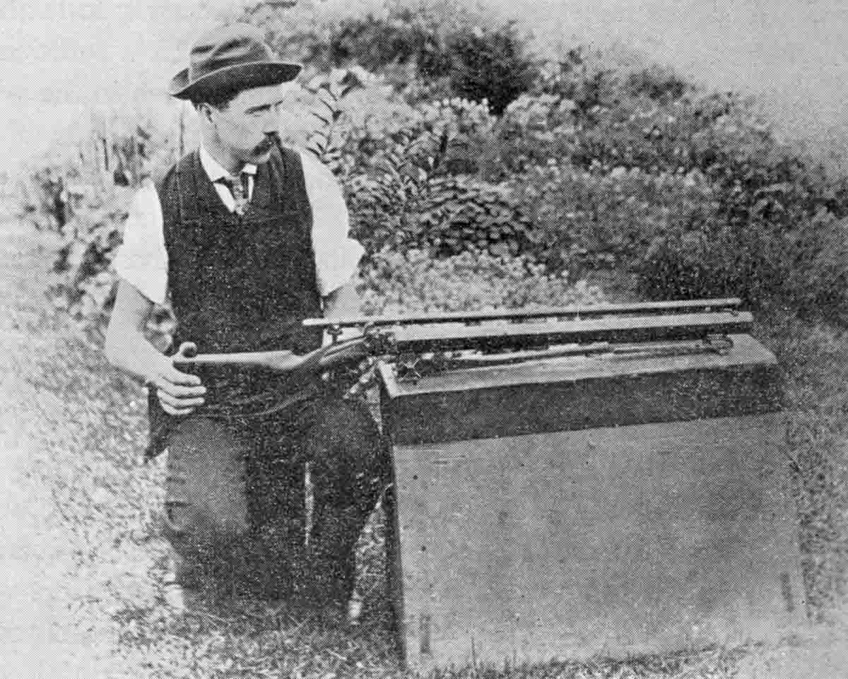 William V. Lowe shooting his Warner rifle from machine rest.
